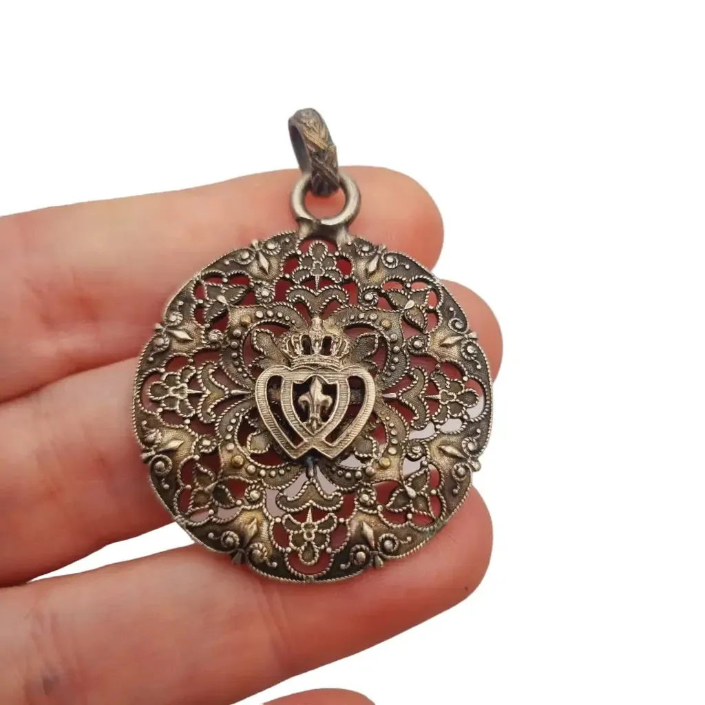 Antique silver Coeur Vendéen rosette, fleur-de-lis and intertwined hearts.