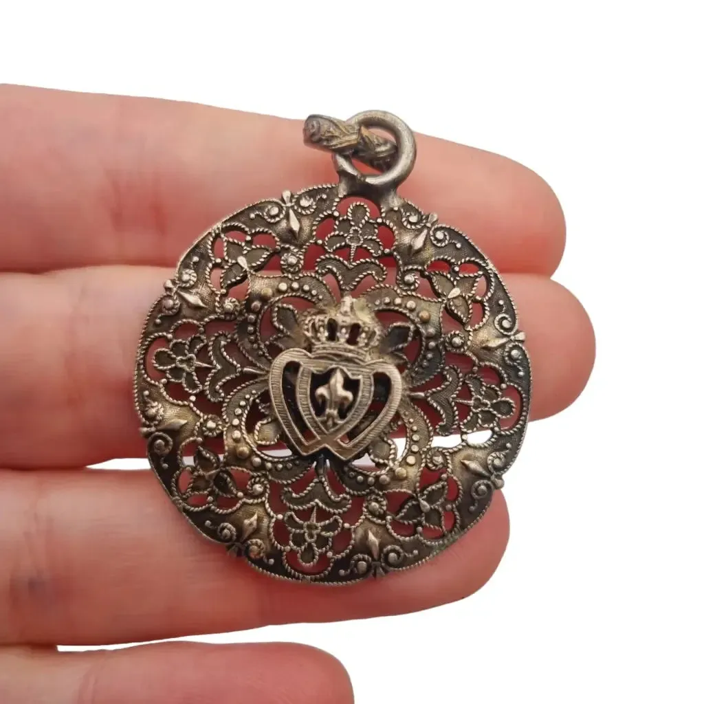 Antique silver Coeur Vendéen rosette, fleur-de-lis and intertwined hearts.