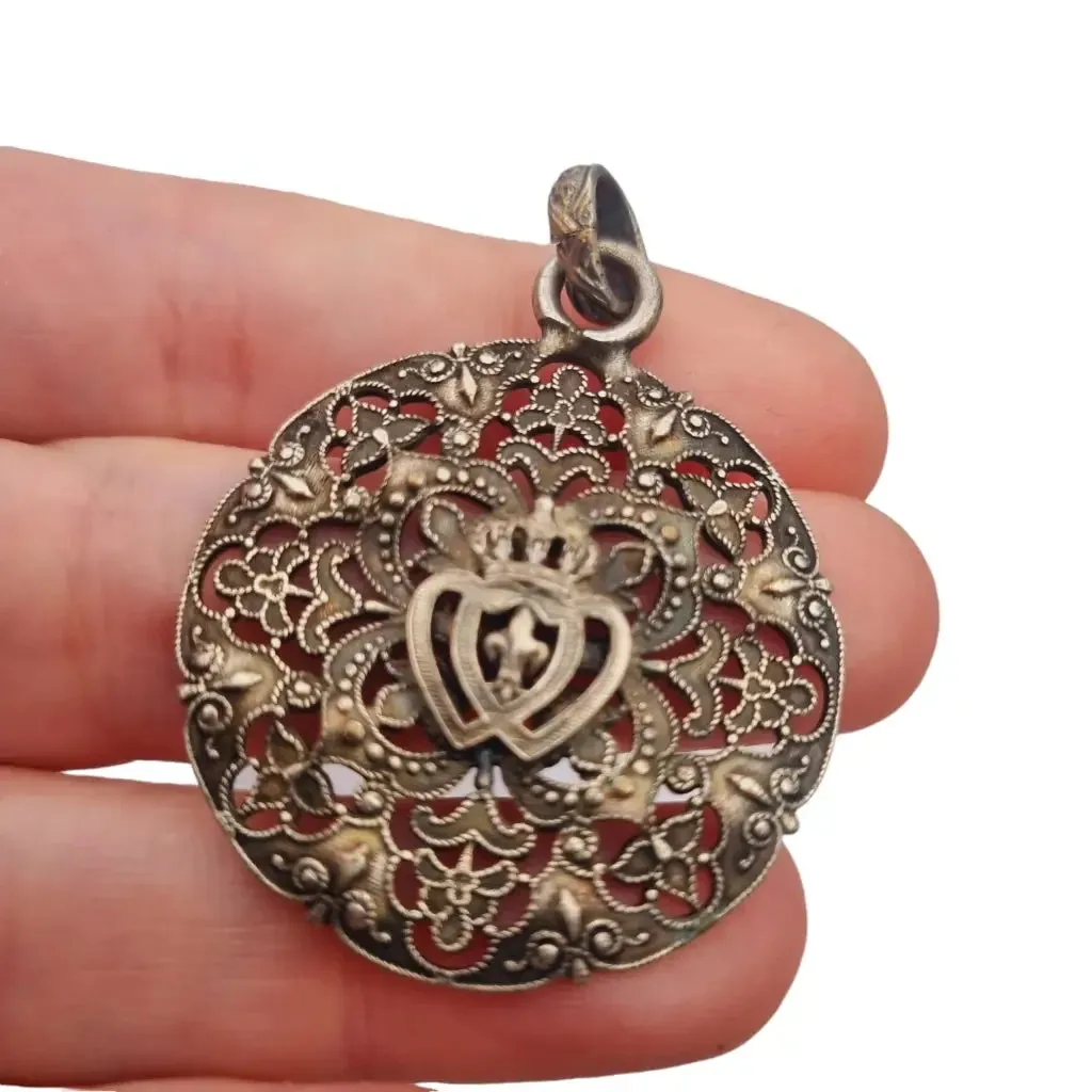 Antique silver Coeur Vendéen rosette, fleur-de-lis and intertwined hearts.