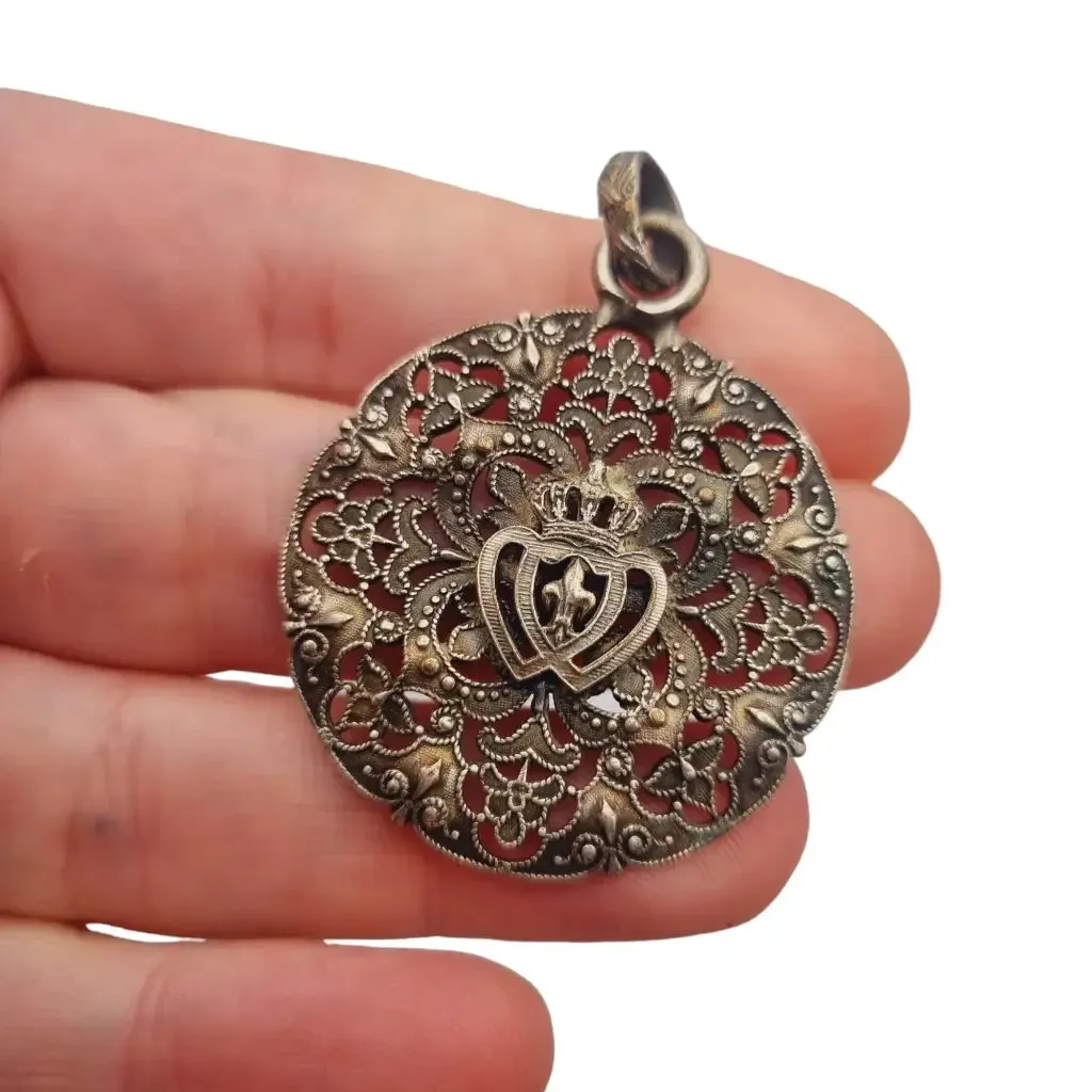 Antique silver Coeur Vendéen rosette, fleur-de-lis and intertwined hearts.